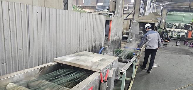 세척 및 분류과정을 거친 폐합성수지가 열 작업을 통해 긴 줄 모양으로 뽑아져 나오고 있다. 석현철기자