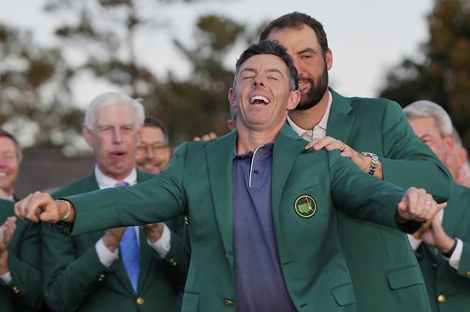 2024년 마스터스 우승자 스코티 셰플러가 2025년 마스터스에서 우승한 로리 매킬로이에게 그린 재킷을 입혀주고 있다.&nbsp;AP연합뉴스