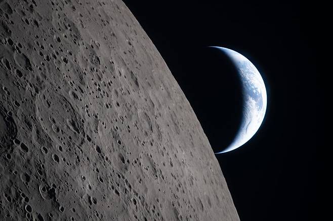 [워싱턴=AP/뉴시스] 미 항공우주국(NASA)이 6일(현지 시간) 제공한 사진에 아르테미스 II 우주선이 달 근접 비행 중 달 뒤로 지구가 지는 모습이 관측되고 있다. NASA는 달 근접 비행을 마친 유인 달 탐사선 아르테미스 2호가 달 중력권을 벗어나 지구로 귀환할 것이라고 밝혔다. 2026.04.08.