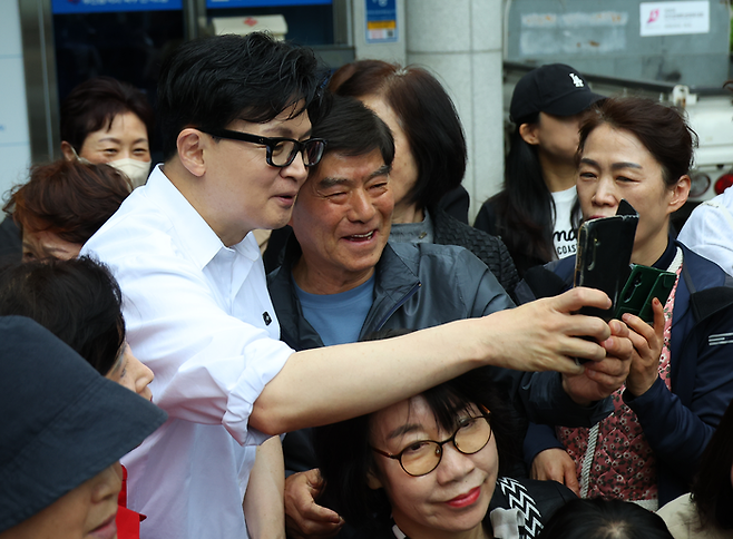 한동훈 전 국민의힘 대표가 14일 오후 부산 북구 만덕2동 행정복지센터를 찾아 전입신고를 마친 뒤 주민들과 사진을 찍고 있다. <연합뉴스>