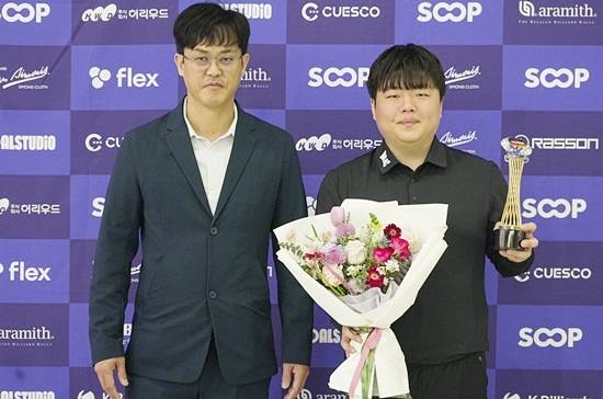 대한당구연맹 허해용 수석부회장이 조명우에게 축하 꽃다발을 건넨 후 기념촬영하고 있다. (사진=대한당구연맹)