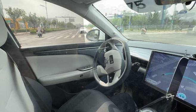 지난 17일 베이징의 한 도로에서 중국 자율주행 기술기업 포니에이아이(AI)의 무인택시가 핸들을 꺾어 좌회전을 하고 있다. 베이징/이정연 특파원