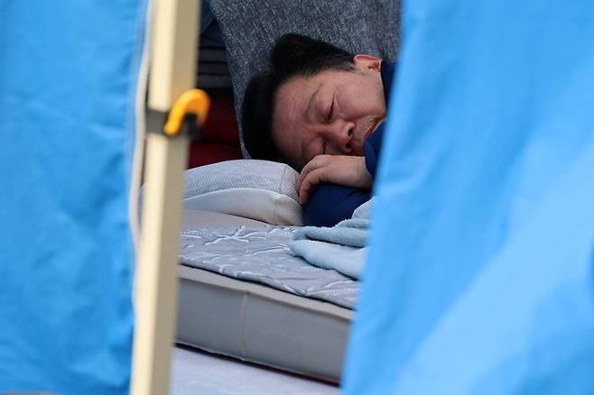 단식 12일째인 더불어민주당 안호영 의원이 22일 국회 본청 앞 천막 농성장에 누워 있다. 연합뉴스