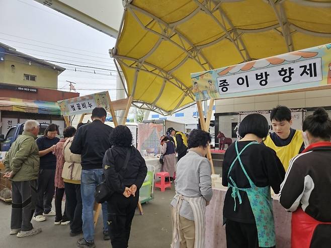 성주전통시장 일원에서 열린 성주군 생활밀착형 문화사업 ‘일상 가까이 생문터 ART ON’ 행사에서 지역 주민과 방문객들이 벚꽃비누 및 종이방향제 만들기 체험 부스에 참여하며 즐거운 시간을 보내고 있다. /성주군 제공