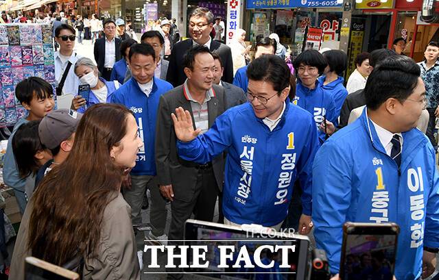 정원오 더불어민주당 서울시장 후보(가운데)가 25일 오후 서울 중구 남대문시장을 찾아 시민들과 인사를 하고 있다. /박상민 기자