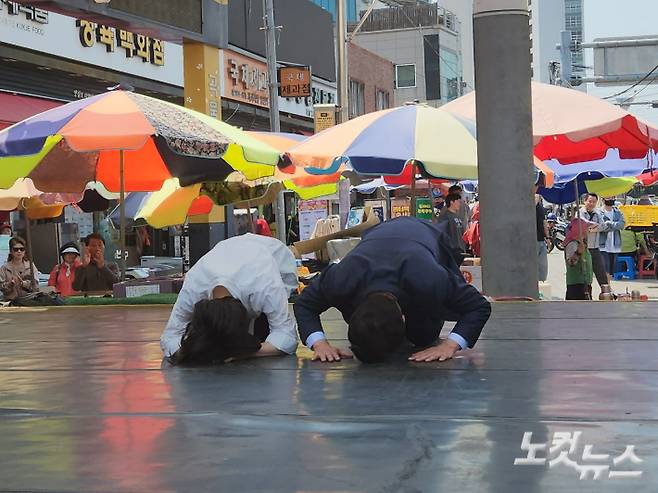 전재수 더불어민주당 부산시장 후보가 27일 부산 북구 구포시장에서 주민들에게 감사 인사를 전하며 큰절을 하고 있다. 정혜린 기자
