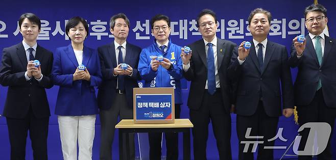 정원오 더불어민주당 서울시장 후보가 28일 서울 중구 선거대책위원회 사무실에서 열린 공개 선거대책위원회 회의에서 상임선대위원장들과 함께 서울 25개 자치구 정책 공약을 택배상자에 넣는 퍼포먼스를 하고 있다. 2026.4.28 ⓒ 뉴스1 오대일 기자
