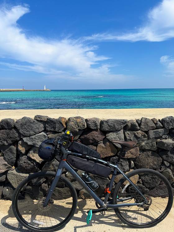 The reporter's fully loaded bike outside the Sehwa Fifth-Day Market in Jeju on April 5. [JIM BULLEY]