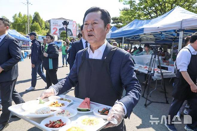 [서울=뉴시스] 고승민 기자 = 정청래 더불어민주당 대표가 1일 충남 서산시문화회관에서 열린 어버이날 기념 경로행사를 방문, 배식 봉사활동을 하고 있다. (사진=더불어민주당 제공) 2026.05.01. photo@newsis.com