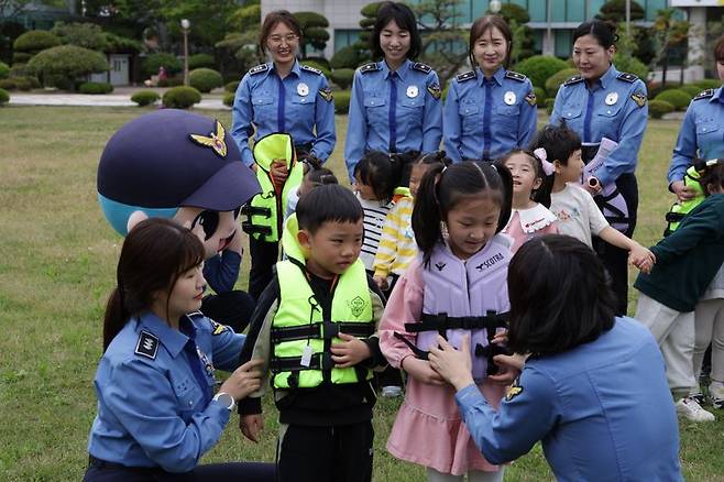남해해경청이 최근 부산해양경찰서와 함께 남해해경청 직장 어린이집에 다니는 원아에게 구명조끼 착용 교육을 하는 모습. 남해해경 제공