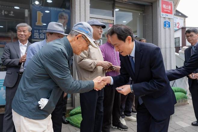 우상호 더불어민주당 강원도지사 후보가 지역민들과 악수하며 인사를 나누고 있다. 정선=윤예솔 기자