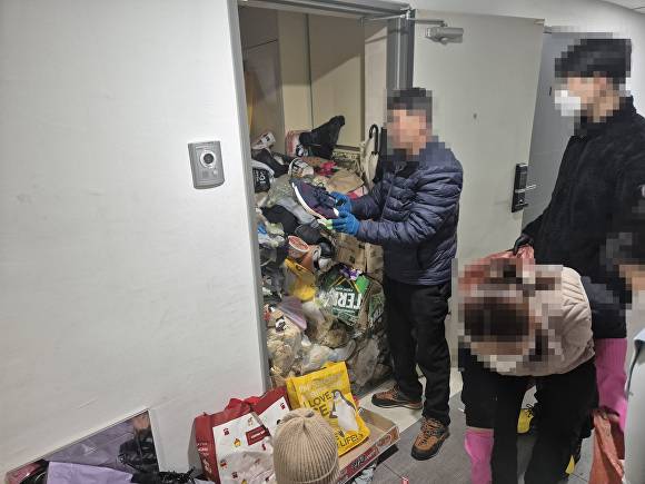 천안시 관계자들과 봉사자들이 한 가구를 방문해 생활 폐기물을 수거하고 방역 작업을 펼치고 있다 [사진=천안시]