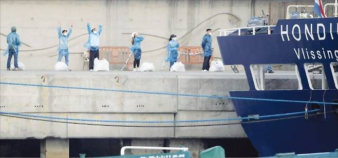 11일(현지시간) 스페인령 카나리아제도 테네리페항에 정박한 유람선 혼디우스호에서 내린 관광객들이 이동하기 위해 대기하고 있다. 한타바이러스 집단 감염이 발생한 선박이 항구에 입항했다.   AFP연합뉴스