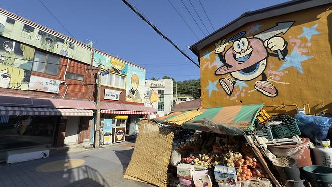 Webtoon characters appear across storefront signboards and walls at Webtoon Ibagu-gil in Beomil-dong, Dong DIstrict, on May 5. [WOO JI-WON]