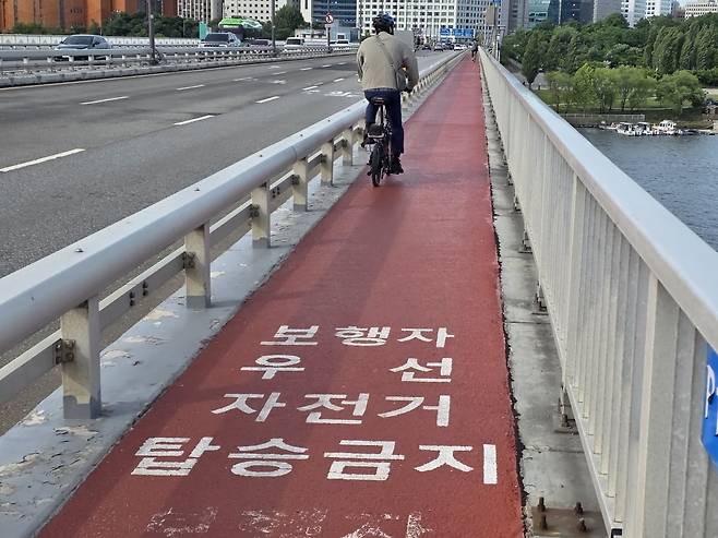 자전거 탑승이 금지된 서강대교 위에서 자전거를 타고 한 시민이 지나가고 있다. /사진=이정우 기자