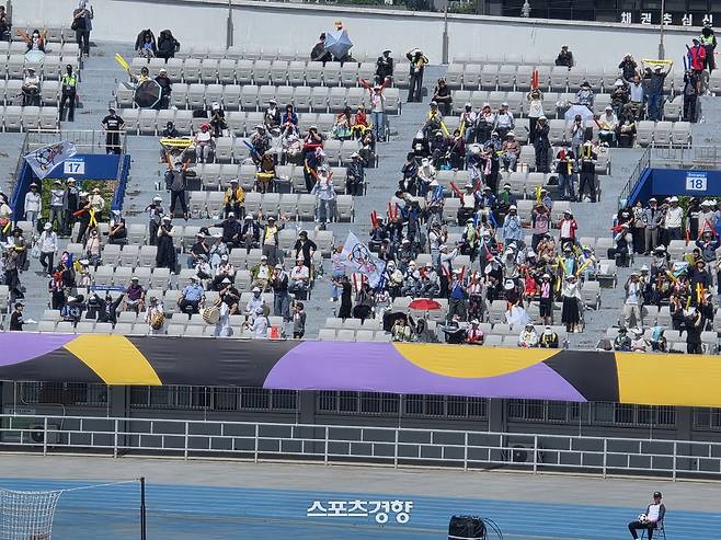 한 관중이 23일 수원종합운동장에서 열린 2025~2026 아시아축구연맹 여자 챔피언스리그 결승전에서 전반 44분 김경영의 선제 결승골이 터지자 내고향 깃발을 들고 질주하고 있다.   수원 | 윤은용 기자