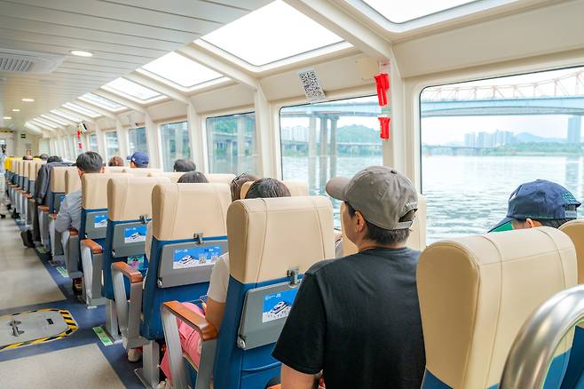 Riders sit inside a Hangang Bus ferry. [SEOUL TOURISM ORGANIZATION]
