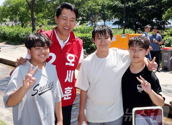 오세훈 국민의힘 서울시장 후보가 30일 오후 서울 영등포구 여의도 한강공원을 찾아 아이들과 기념 사진을 찍고 있다. 2026.5.30 ⓒ 뉴스1 김진환 기자