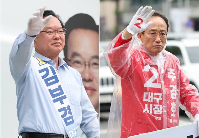 더불어민주당 김부겸 대구시장 후보(왼쪽)와 국민의힘 추경호 대구시장 후보가 2일 대구 중구 반월당사거리와 북구 복현오거리에서 각각 아침 인사를 하고 있다. 연합뉴스