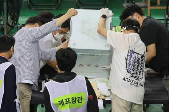5일 서울 송파구 잠실7동 제2투표소에서 이송된 투표함이 개표소인 올림픽공원 핸드볼경기장에 도착해 참관인이 지켜보는 가운데 투표함을 열고 있다. (연합뉴스)