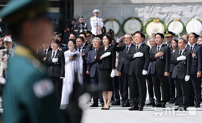 [서울=뉴시스] 고범준 기자 = 이재명 대통령과 김혜경 여사가 6일 서울 동작구 국립서울현충원에서 열린 제71회 현충일 추념식에서 현충탑 참배 후 국기에 경례를 하고 있다. (청와대통신사진기자단) 2026.06.06. bjko@newsis.com