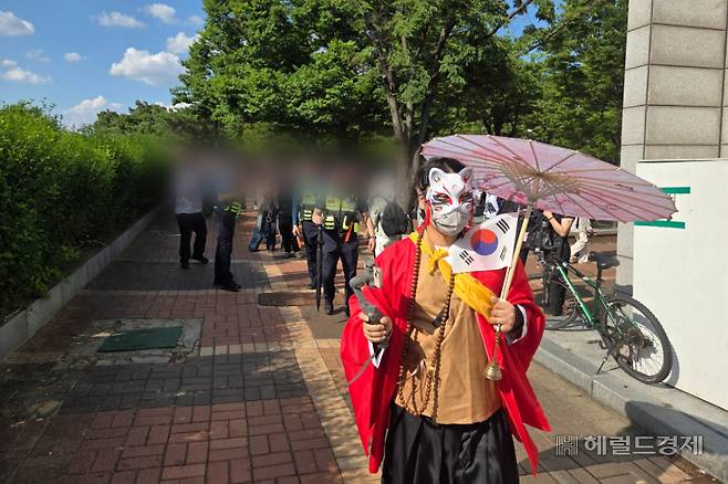8일 오후 4시20분께 서울 송파구 올림픽공원에서 이어지는 투표용지 부족 사태 반발 집회에서 한 남성 참가자가 ‘선동 세력’으로 의심받아 쫓겨나고 있다. 이영기 기자