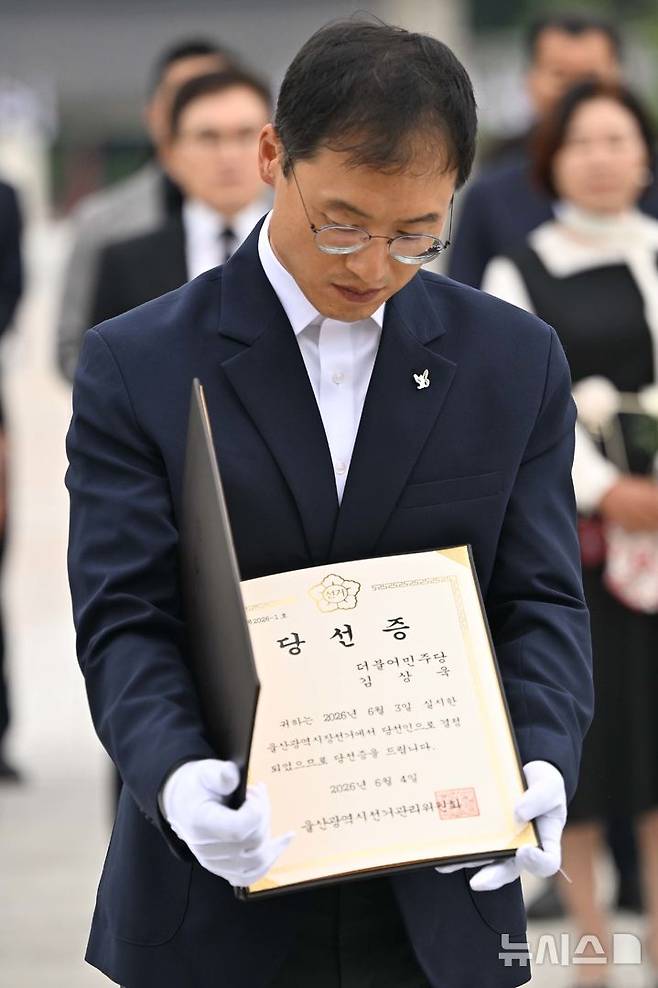[광주=뉴시스] 이영주 기자 = 김상욱 더불어민주당 울산시장 당선인이 8일 오전 광주 북구 운정동 국립5.18민주묘지를 찾아 오월 영령에 울산시장 당선증을 바치고 있다. 2026.06.08. leeyj2578@newsis.com