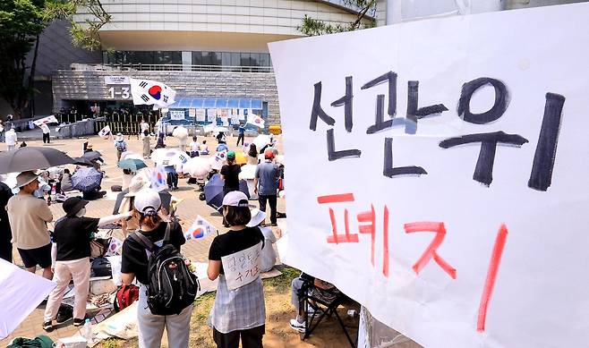 6·3 지방선거 투표용지 부족 사태를 규탄하며 재선거를 요구하는 집회가 엿새째 이어지고 있는 10일 서울 송파구 올림픽공원 핸드볼경기장 개표소 앞에 시민들이 모여 구호를 외치고 있다. 뉴스1