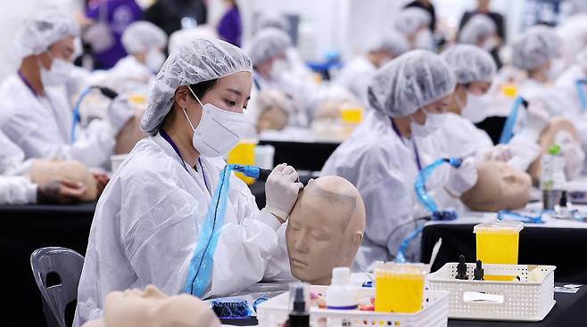 작년 9월 서울 강남구 SETEC 1전시장에서 열린 국내 최초 문신산업박람회 ‘PTS문화예술대전'에서 타투 경연 참가자들이 작업하고 있다./뉴스1