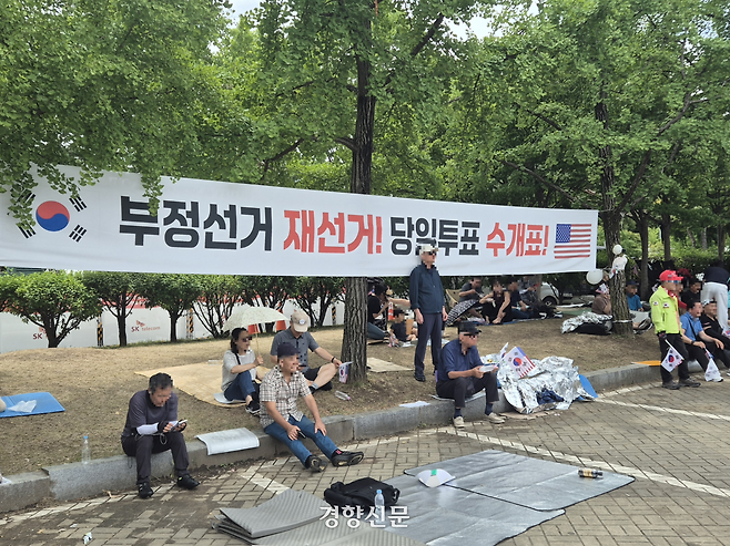 ‘부정선거 재선거’ 등 구호가 적힌 현수막이 21일 서울 송파구 올림픽공원 ‘개표소 봉쇄 시위’ 현장에 설치돼 있다. 김태욱 기자