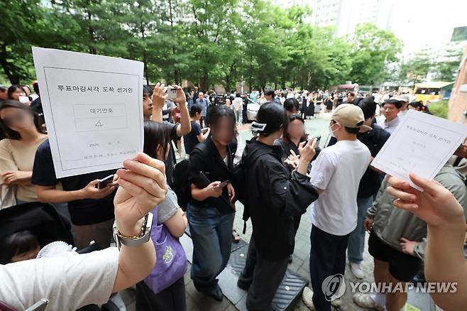 투표 마감 시간 이후 투표 가능 (서울=연합뉴스) 김주형 기자 = 6·3 지방선거 본투표일인 3일 서울 송파구 잠실2동6투표소에서 투표용지 부족으로 유권자들이 대기하는 등 혼란이 빚어지고 있다. 
     한 시민이 투표 마감시간 이후 순서대로 투표가 가능하도록 정한 대기표를 받아 보여주고 있다. 2026.6.3 kjhpress@yna.co.kr