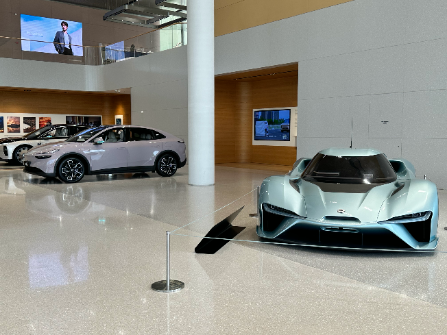 The NIO EP9 (right), a track-only electric supercar developed with NIO’s Formula E racing team, and other vehicle models are displayed at NIO House exhibition center in Hefei, China, on June 12. (Byun Hye-jin/The Korea Herald)