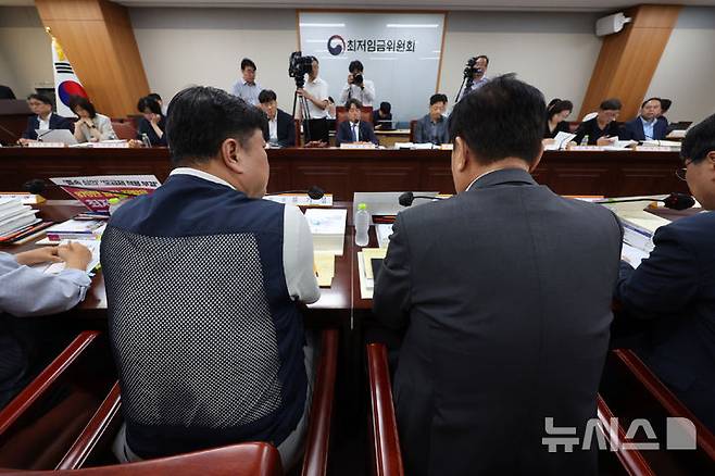 [세종=뉴시스] 배훈식 기자 = 최저임금위원회 류기섭(왼쪽) 근로자 위원과 류기정 사용자 위원이 2일 오후 세종시 정부세종청사에서 열린 최저임금위 제11차 전원회의에서 나란히 앉아 있다. 2026.07.02. dahora83@newsis.com