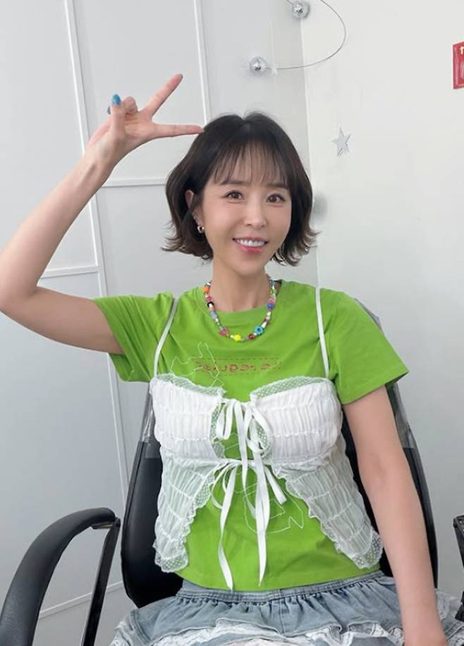 Singer Shin Ji shared a photo on her social media expressing her excitement ahead of her first performance in a long time. Ahead of the show, Shin Ji flashed a bright smile, showing her dedication to her career as a singer.In the photo, Shin Ji paired a green short-sleeved T-shirt with a sky-blue lace skirt to create a fresh and vibrant look. She also showcased an outfit accented with a beaded necklace and expressed her joy by striking a V sign for the camera.Meanwhile, Shin Ji garnered significant attention last month after marrying singer Moon Won.