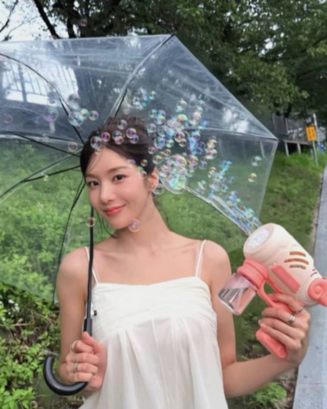Singer Kwon Eun-bi captivated fans attention by showcasing an innocent and lovely summer style through her personal channel. Kwon Eun-bi created a photoshoot-worthy atmosphere in a refreshing outfit consisting of a white slip top and black shorts.In the released video, Kwon Eun-bi wore an outfit featuring prominent lace details and emphasized her innocent charm by utilizing a transparent umbrella and soap bubbles. Displaying both healthiness and innocence with just a slip top and shorts, she revealed a presence befitting the title of Waterbomb Goddess.Meanwhile, fans are expressing disappointment as there is no news regarding Kwon Eun-bis appearance at Waterbomb this year. Through this post, Kwon Eun-bi communicated with fans by sharing her daily life, which is brimming with summer vibes.