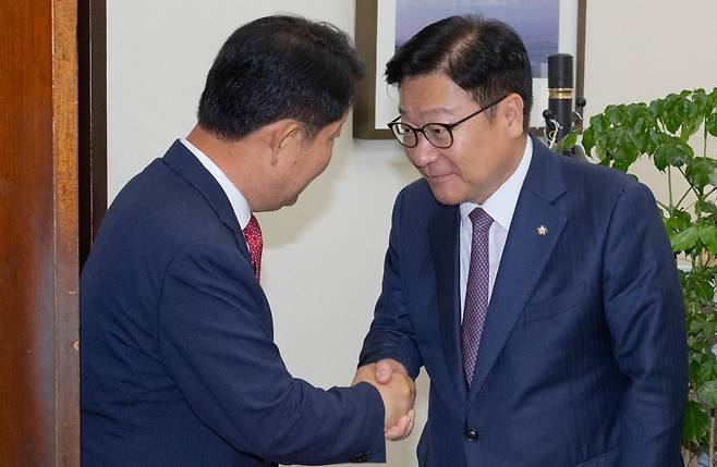 22대 하반기 국회 상임위원회 배정 기준에 불만을 제기하는 과정에서 국민의힘 정점식 원내대표(오른쪽)의 멱살을 잡았던 권영진 의원이 27일 국회 내 원내대표실을 방문해 사과한 뒤 배웅하는 정 원내대표와 악수하고 있다. 연합뉴스