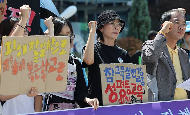 24일 서울 서초구 서울행정법원 앞에서 열린 지혜복 교사 부당해임 취소소송 선고결과에 대한 A학교 공대위 입장 발표 기자회견에서 해임 무효 판결을 받은 지혜복 교사가 구호를 외치고 있다. 연합뉴스