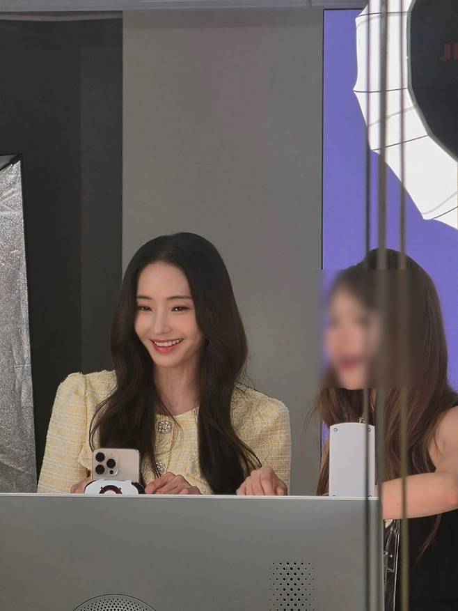 Actress Han Chae-young showcased her unchanging, Barbie Doll-like beauty by sharing everyday photos taken while waiting for filming. Han Chae-young flaunted her radiant visuals by posting behind-the-scenes photos on her social media account.In the released photos, Han Chae-young is wearing a light yellow tweed dress and smiling brightly. Despite being on standby before filming, she captivated viewers with an atmosphere reminiscent of a scene from a movie.Her natural interactions with the staff on set also drew attention. Born in 1980, Han Chae-young drew admiration from fans by displaying both her enduring innocence and sophisticated charm.