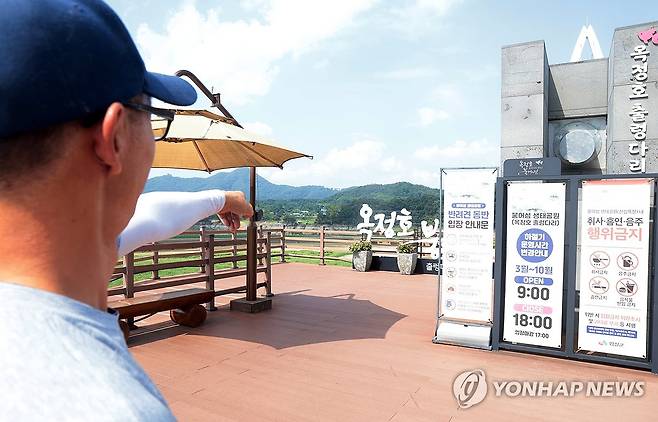 '메마른 옥정호를 바라보며' (임실=연합뉴스) 김문경 기자 = 전북에 폭염이 이어진 6일 임실군 운암면 붕어섬 생태공원에서 직원이 옥정호의 낮아진 수위를 설명하고 있다. 2026.8.6 door@yna.co.kr