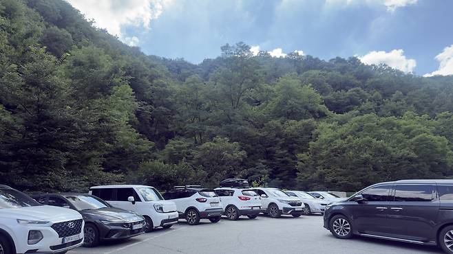 A parking lot near a valley in Namhansanseong is packed with cars. WOO JI-WON