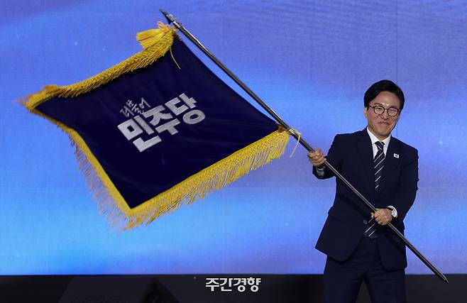 김민석 신임 더불어민주당 대표가 지난 8월 17일 대전 컨벤션센터에서 열린 제3회 민주당 정기 전국당원대회에서 당기를 흔들고 있다. 권도현 기자