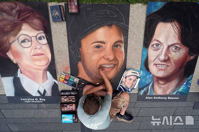 [섕크스빌=AP/뉴시스] 미 911 테러 25주년을 하루 앞둔 10일(현지 시간) 미 펜실베이니아주 섕크스빌 플라이트93 국립추모공원에서 초크 아티스트 에릭 그리너월트가 911 테러 당시 추락한 유나이티드(UA)항공 93편 희생자들의 초상화를 그리고 있다. 그리너월트는 미국 전역에서 초크 아티스트 11명을 초청해 당시 희생된 UA93편 승무원·승객 40명의 초상화를 그리고 있다. 2026.09.11.