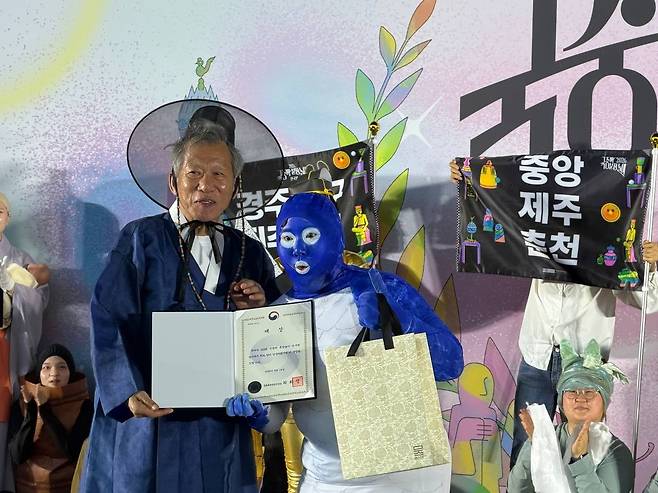 19일 서울 용산구 국립중앙박물관에서 열린 ‘2026 국중박 분장놀이 전국편’에서 우승한 전은슬씨가 유홍준 국립중앙박물관장으로부터 상장과 상품을 받아들고 기뻐하고 있다.    연합뉴스