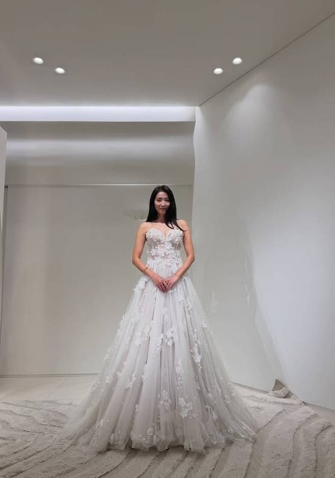 Actress Oh Yoon-ah showed off her dazzling figure in wedding dresses.On the 22nd, Oh Yoon-ah posted several photos along with the caption, Which one should I choose?The photos released captured Oh Yoon-ah posing in white wedding dresses of various designs.Wearing a ballgown dress featuring a voluminous silhouette, Oh Yoon-ah created an innocent atmosphere by holding the hem of the skirt with both hands.In another photo, she showed off a contrasting charm wearing a mermaid dress that highlighted her body line.In particular, a dress combining floral lace and sheer details further accentuated Oh Yoon-ahs slender silhouette.Adding to her innocent charm with long straight hair and natural makeup, Oh Yoon-ah perfectly pulled off the various wedding dress designs.Born in 1980, Oh Yoon-ah debuted in 2000 and is currently active in the entertainment industry.Last July, she received many congratulations after announcing her remarriage to a non-celebrity. Photo = Oh Yoon-ah