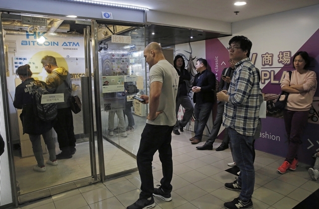 12월8일(현지시간) 홍콩의 비트코인 자동입출금기(ATM) 앞에 시민들이 길게 늘어서 있다. 연합뉴스