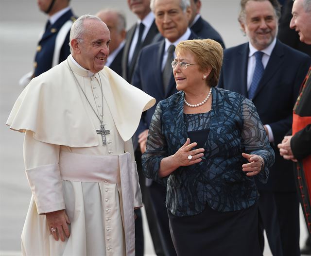 프란치스코 교황(왼쪽)이 15일 칠레 수도 산티아고의 아르투로 메리노 베니테스 국제공항에 도착, 미첼 바첼레트 칠레 대통령의 영접을 받고 있다. 산티아고=APF 연합뉴스