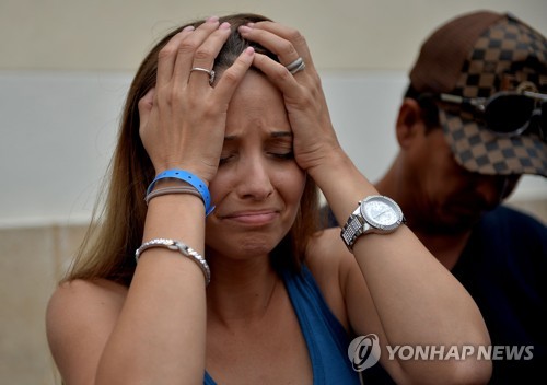 한 여성 생존자의 가족이 병원의 브리핑을 듣고 비통해하고 있다. [AFP=연합뉴스]