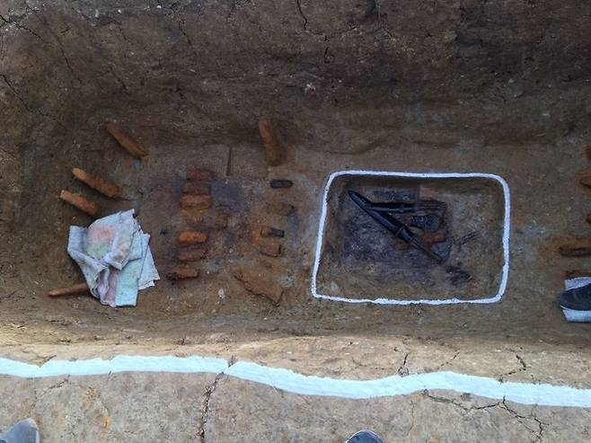 양지리 6호분의 무덤 관 자리 바닥에 있는 요갱(흰줄 쳐진 사각형)의 발굴 당시 모습. 안에 옻칠된 창집들이 보인다.