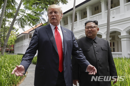 【싱가포르=AP/뉴시스】김정은 북한 국무위원장(오른쪽)과 도널드 트럼프 미 대통령이 12일 싱가포르 센토사섬에 있는 카펠라 호텔에서 오찬을 마친 뒤 산책하던 중 기자들과 이야기하기 위해 걸음을 멈추고 있다. 2018.6.12