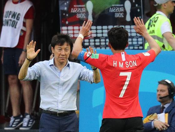 28일 열린 러시아 월드컵 F조 조별리그 3차전 독일전에서 손흥민이 신태용(왼쪽) 축구대표팀 감독과 손을 맞잡으려 하고 있다. 카잔=임현동 기자